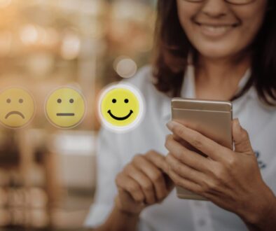 Businesswoman,Pressing,Face,Emoticon,On,Virtual,Touch,Screen,At,Smartphone